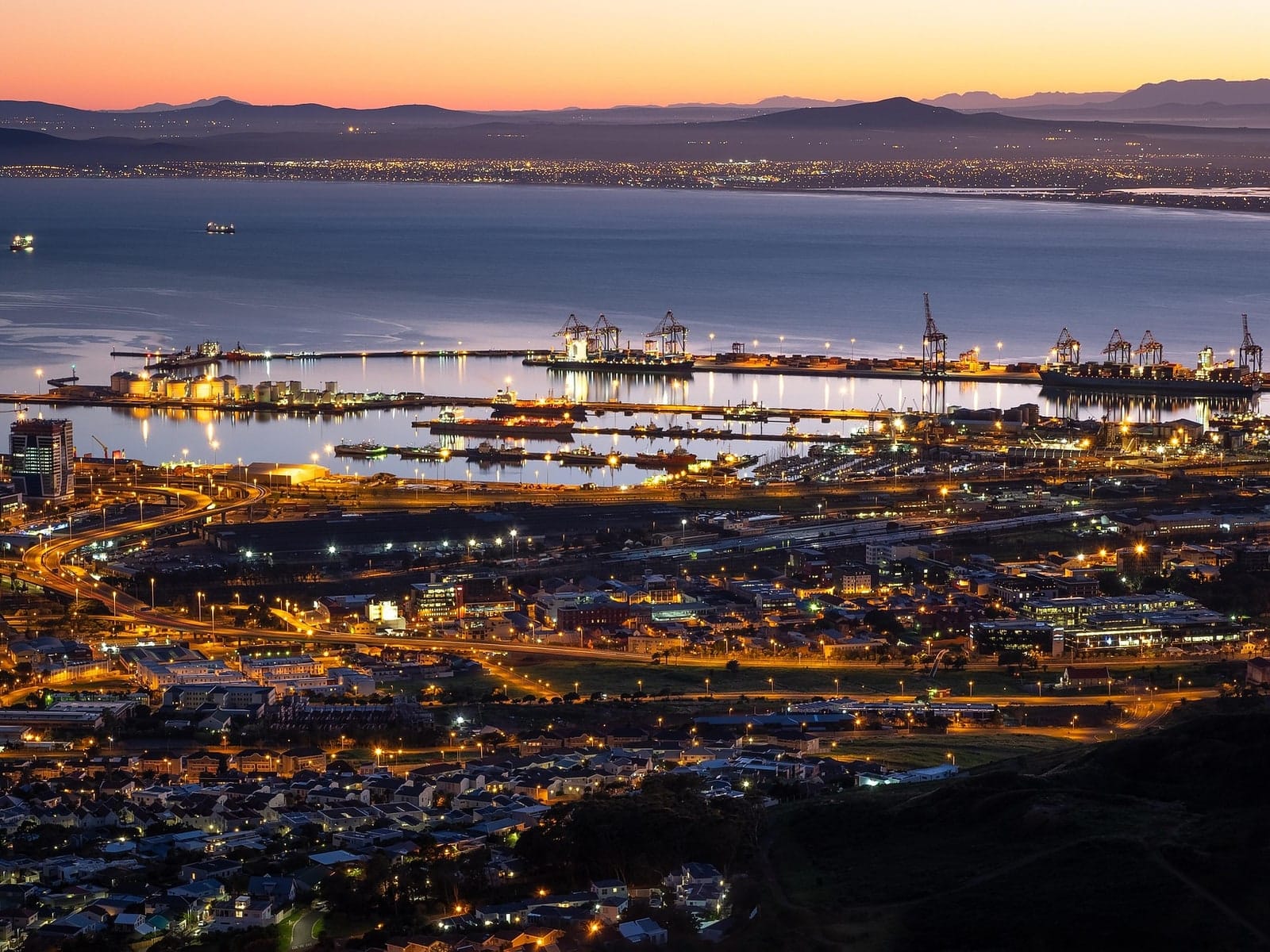 Table Bay harbour and the working port lit up after sunset