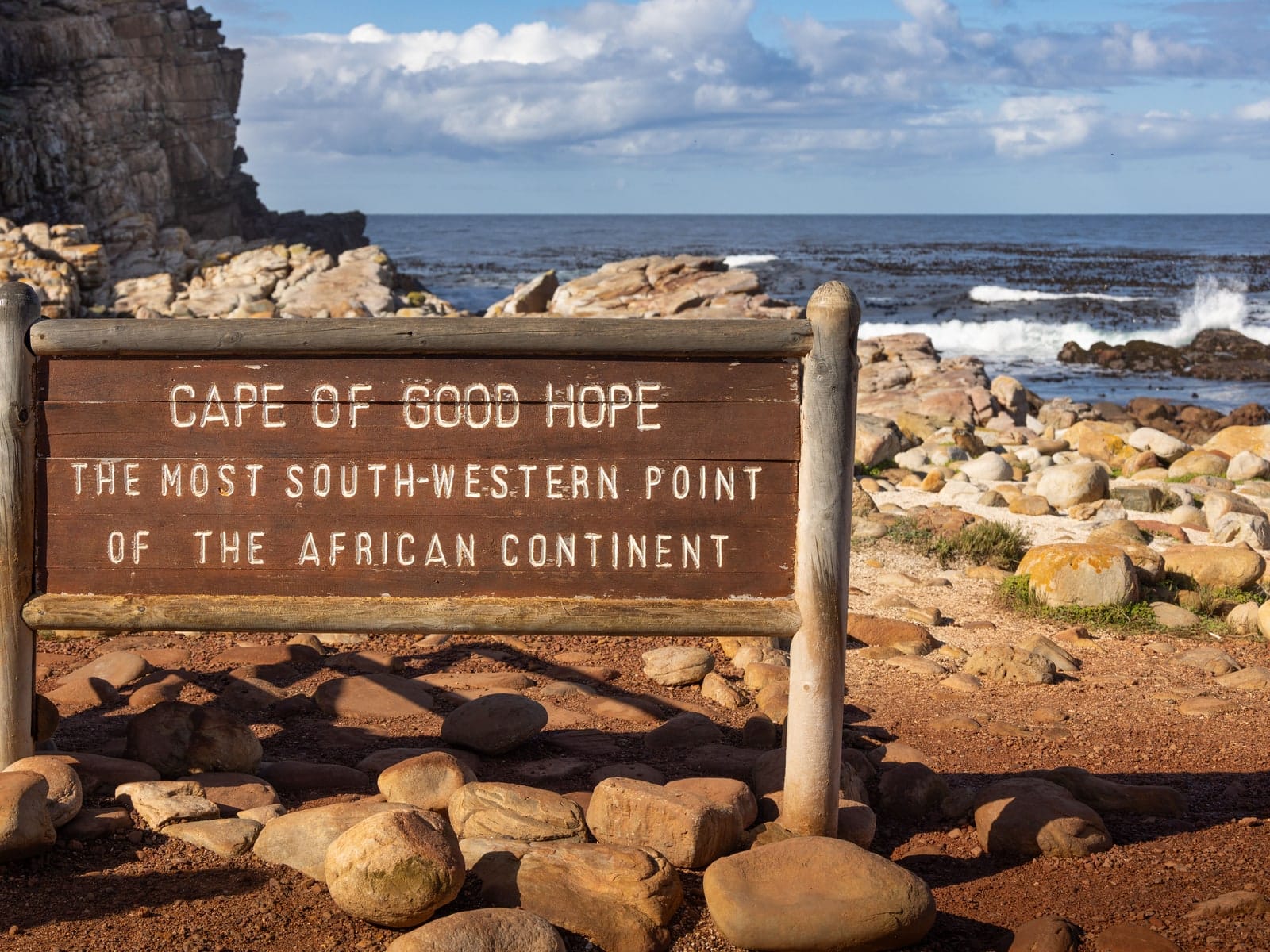 The rocky shoreline at the Cape of Good Hope with fynbos running down to the sea