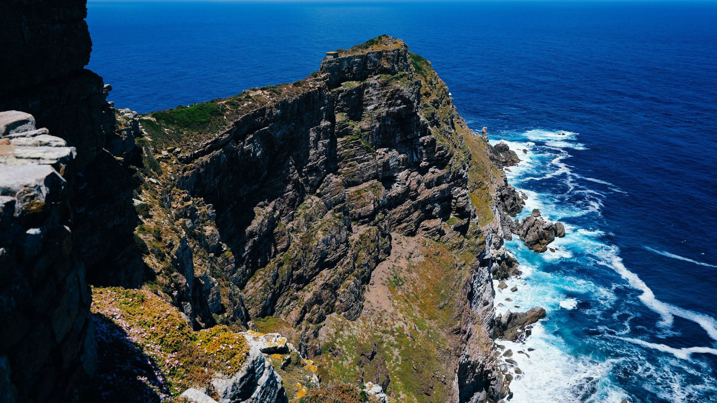 The old lighthouse at Cape Point standing above sheer cliffs and the ocean