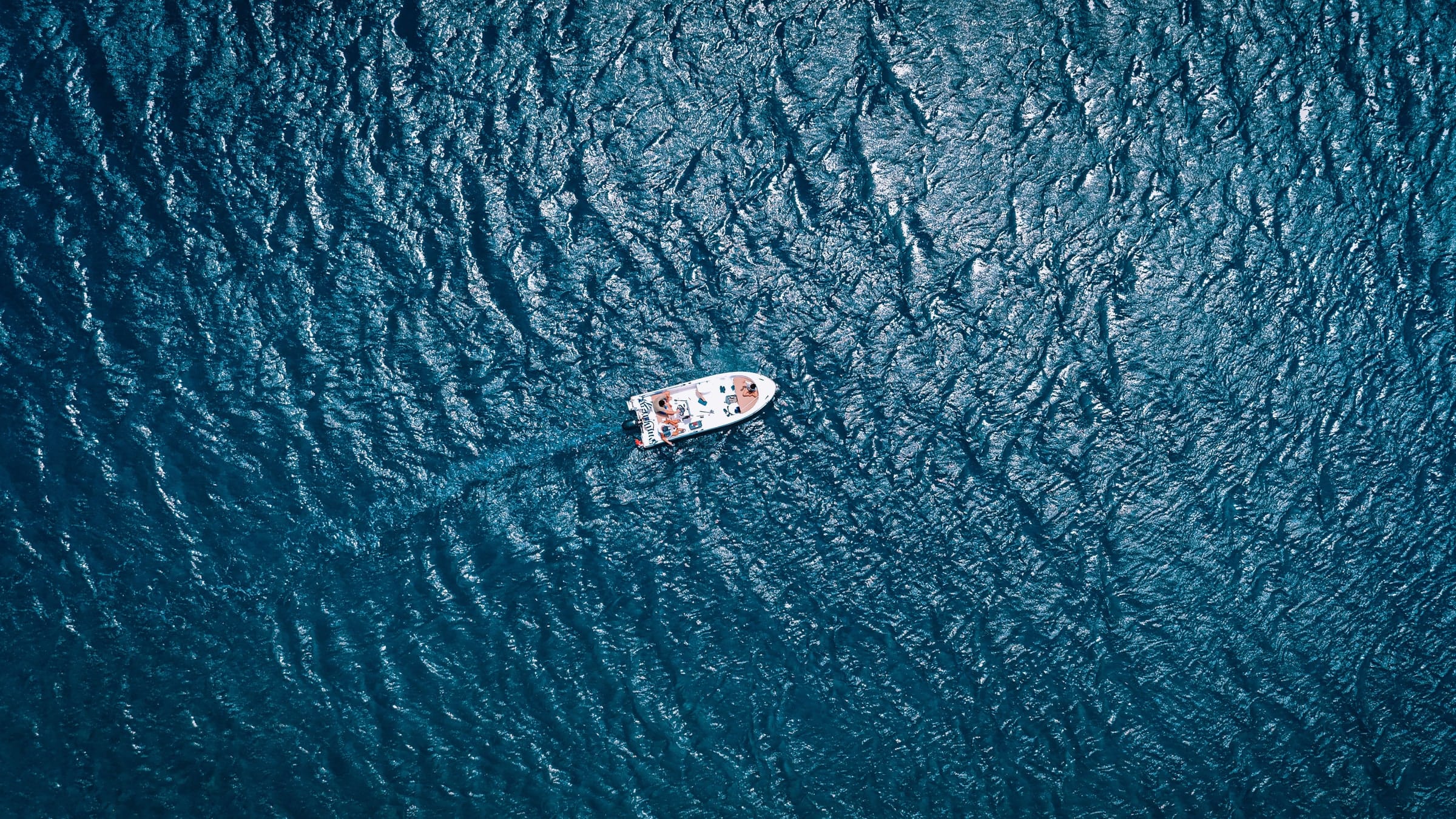 A sport fishing boat heading out through open water off the Cape coast