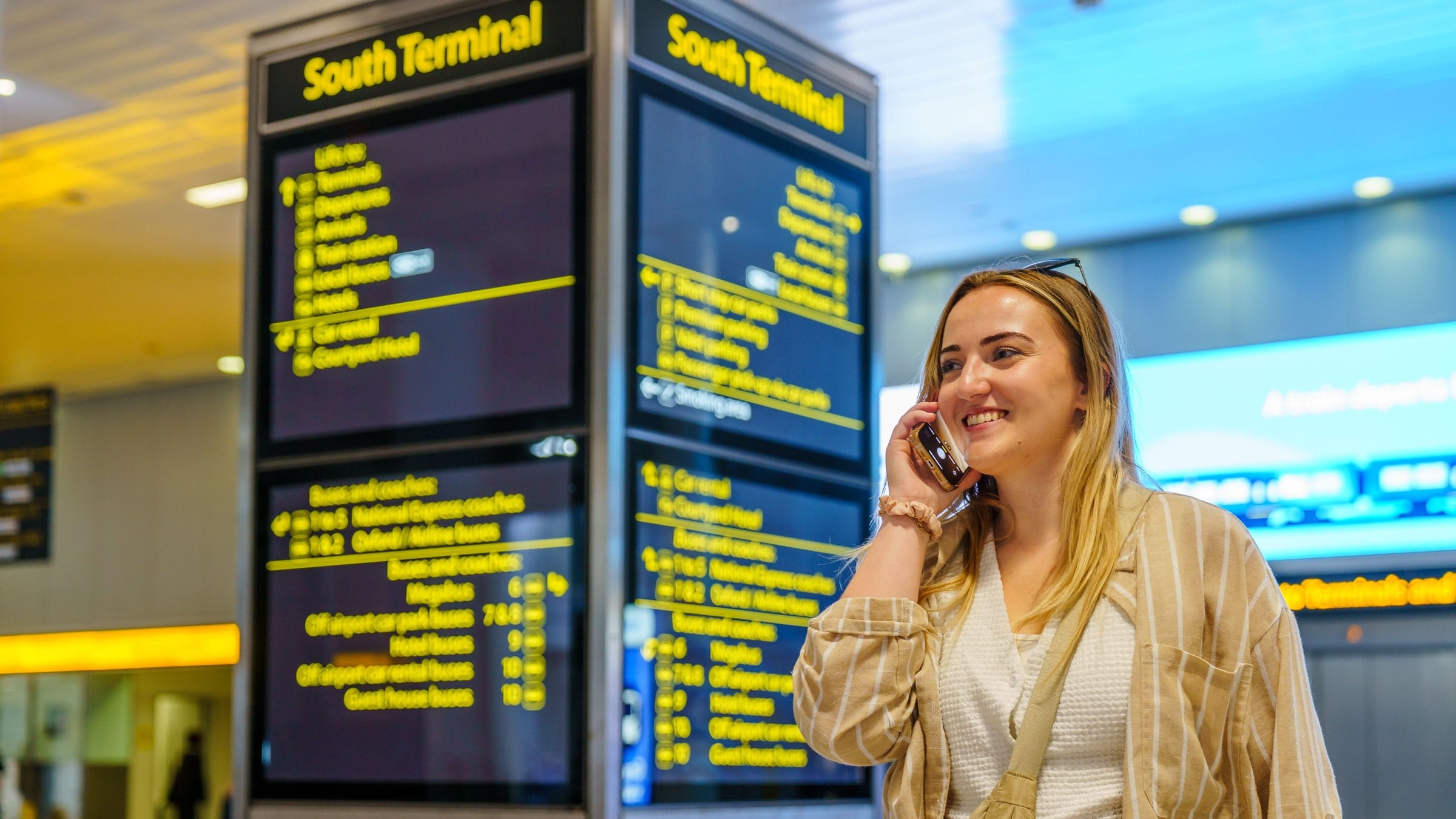 A guide greeting arriving guests inside the airport arrivals hall